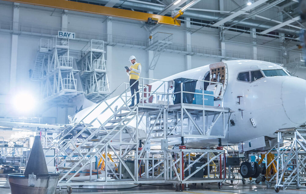 Logistics IT Solutions People working on an airplane using logistics IT solutions