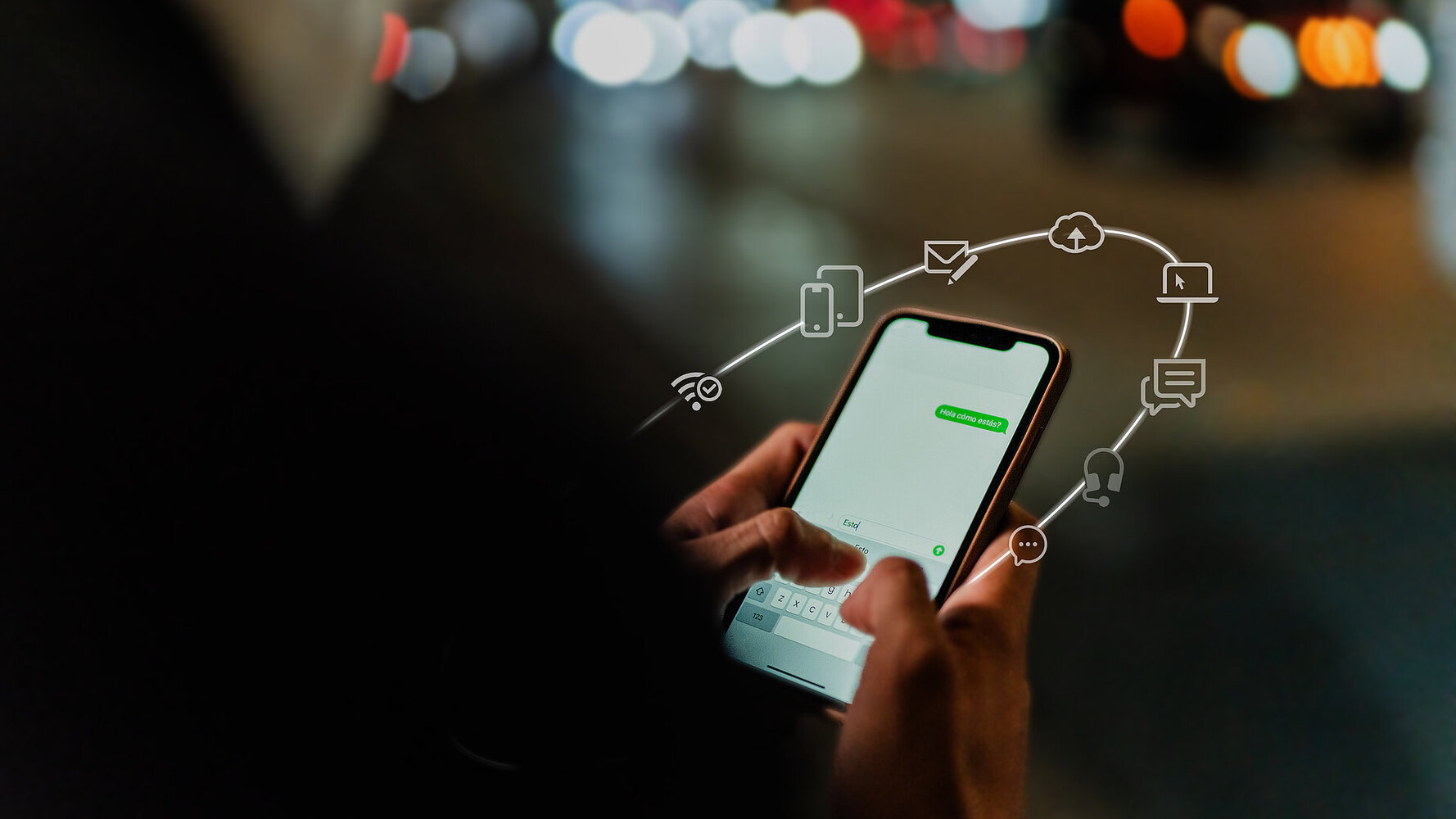 Silhouette of a person from behind, holding a smartphone and typing a message into a chat program. Icons float around the smartphone to illustrate the communication platform.