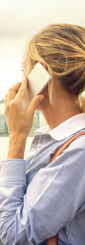Cloud solutions A woman working mobile with cloud solutions by T Business.