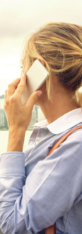 Cloud solutions A woman working mobile with cloud solutions by T Business.