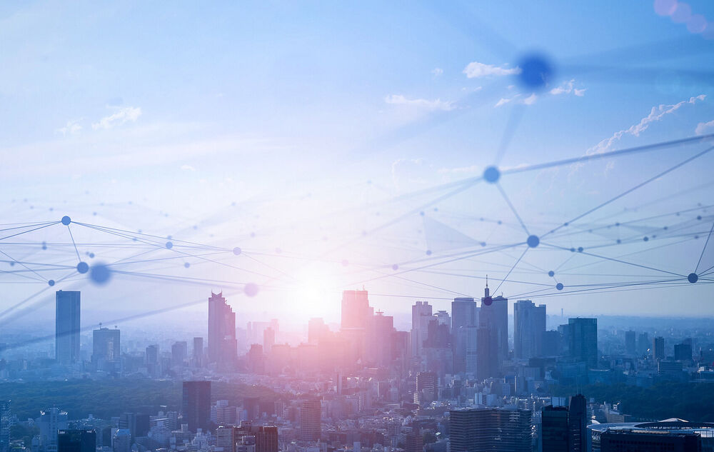 Connectivity solutions The stylized communication networks depicted above a big city skyline illustrate the connectivity solutions from T Business.