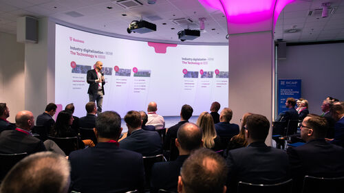 Digital Transformation of Manufacturing Industry The crowd listening to a speaker at the Telekom Business Europe Booth at Digital Transformation of Manufacturing Industry event