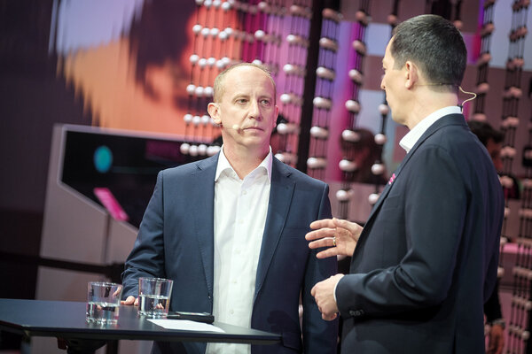 AI Customer Service Marik Csaba engages with János Horváth Varga in a discussion on a stage during the Mobile World Congress (MWC) 2026.