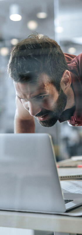 Online Marketing For Small Business A man who works in a small business in the field of online marketing does a pull-up on his desk