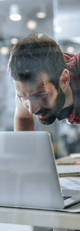 Online Marketing For Small Business A man who works in a small business in the field of online marketing does a pull-up on his desk