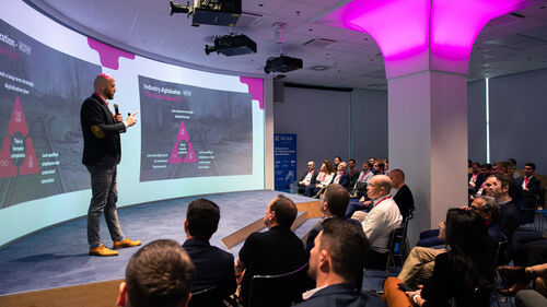 Digital Transformation of Manufacturing Industry A person speaking at the Telekom Business Europe booth at Digital Transformation of Manufacturing