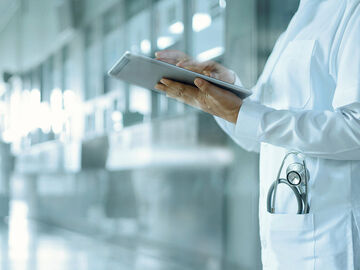 A female doctor with a tablet in search of e-health and telemedicine as part of the government's digital transformation