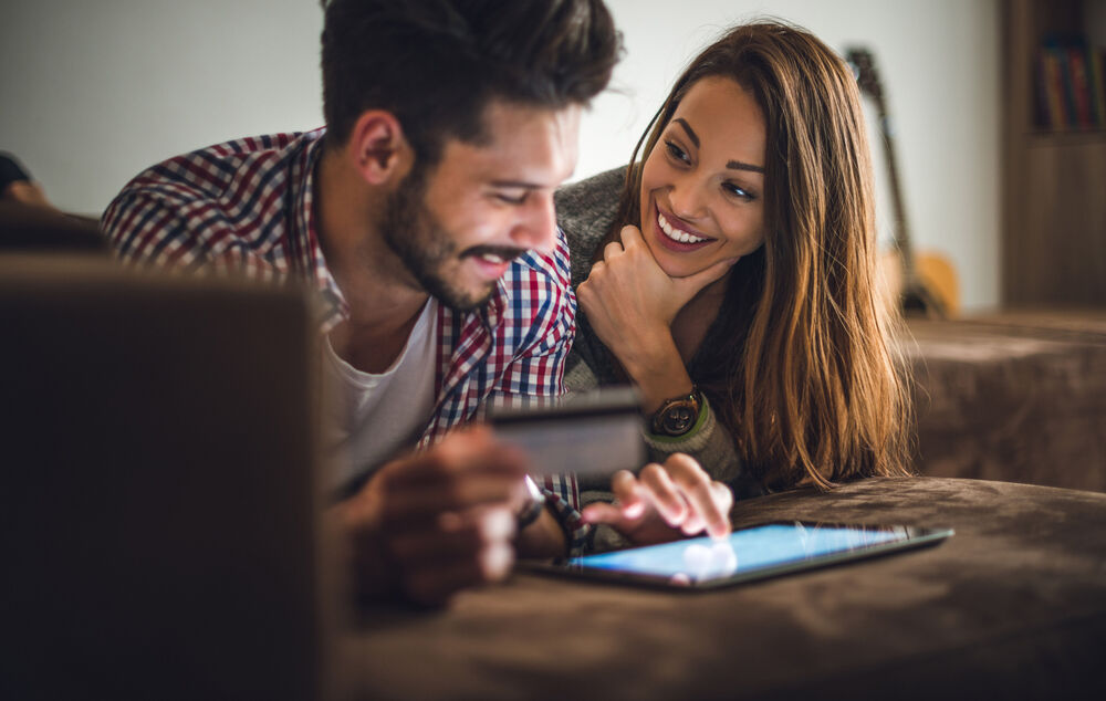 Couple looking for IT solutions for their enterprise on their tablet