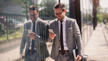 Data security A businessman works mobile with his smartphone, which is organized with Mobile Device Management from T Business to ensure data security.