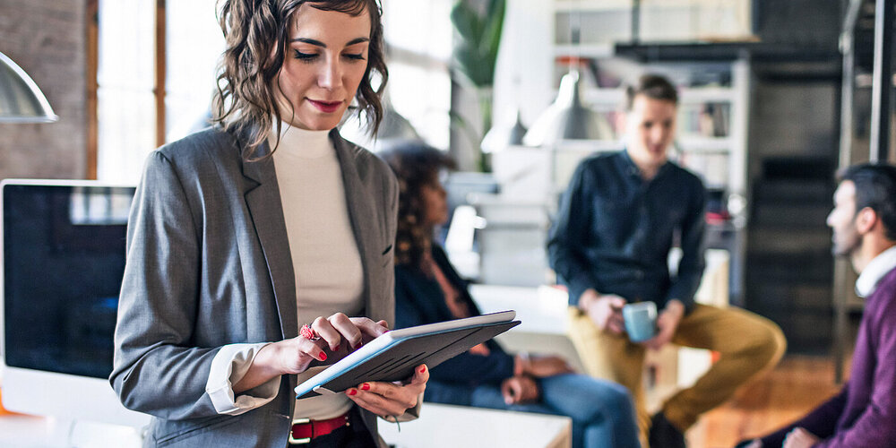 Businesswoman looking for ICT solutions in Europe on her tablet