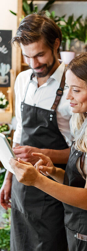 Online Marketing For Small Business Two employees of a garden center talking about the online marketing of their small business
