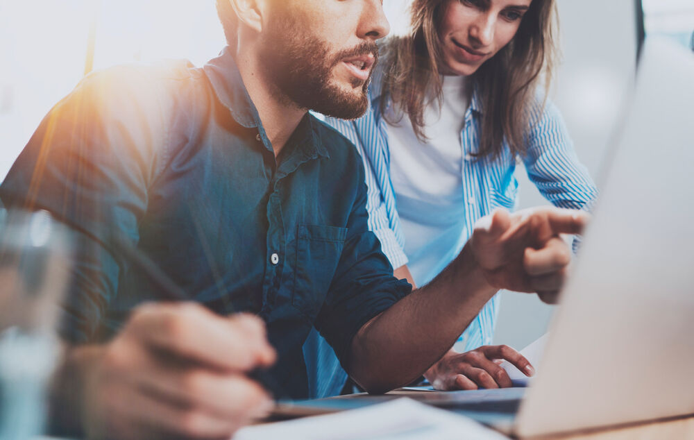 Digitalization Business people in front of a laptop benefit from new work with digitalization by T Business.